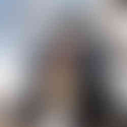 Banff helicopter elopement couple kissing in front of helicopter on a mountain summit