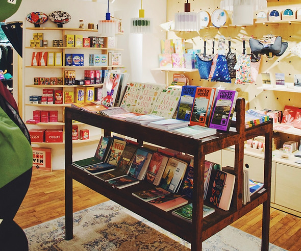 Table en bois avec des livres inspirants, des carnet de jeux et accessoires éco-responsables chez Juste le magasin à Brest.