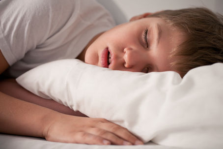 A boy sleeping with his mouth open
