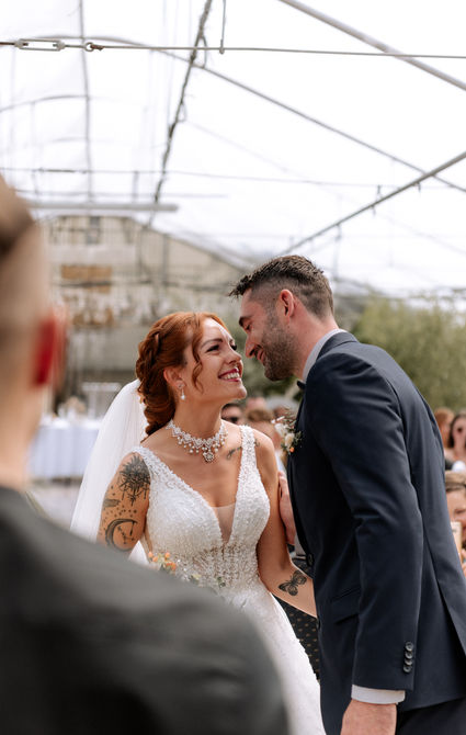 DIY Hochzeit, Freie Trauung Fürstenfeldbruck, das Brautpaar sieht sich vor dem Trauredner das erste Mal und lächelt sich an, kurz vorm Kuss
