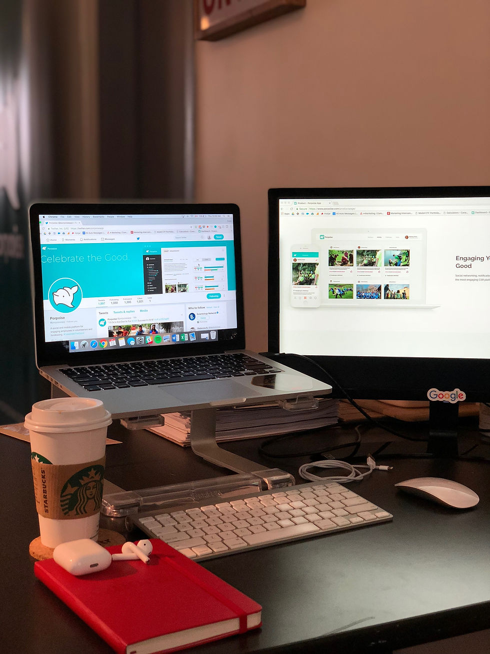 A coffe cup and two laptop terminals showing social media