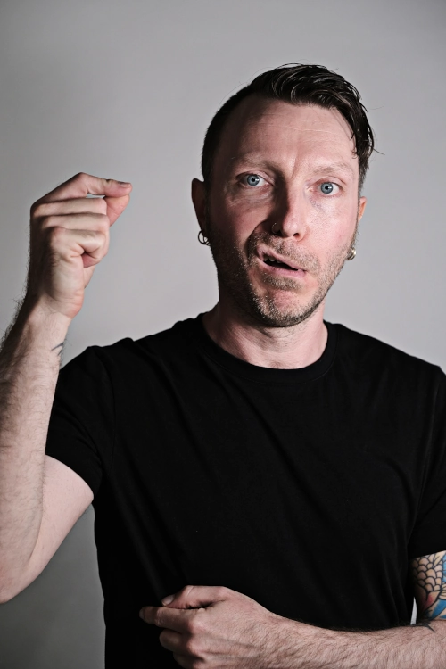 Voice artist Martin Whiskin pulling his lip with a piece of invisible string