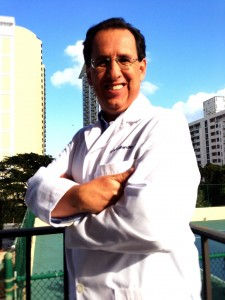 Smiling Robert Samudio, arms crossed, wearing a lab coat
