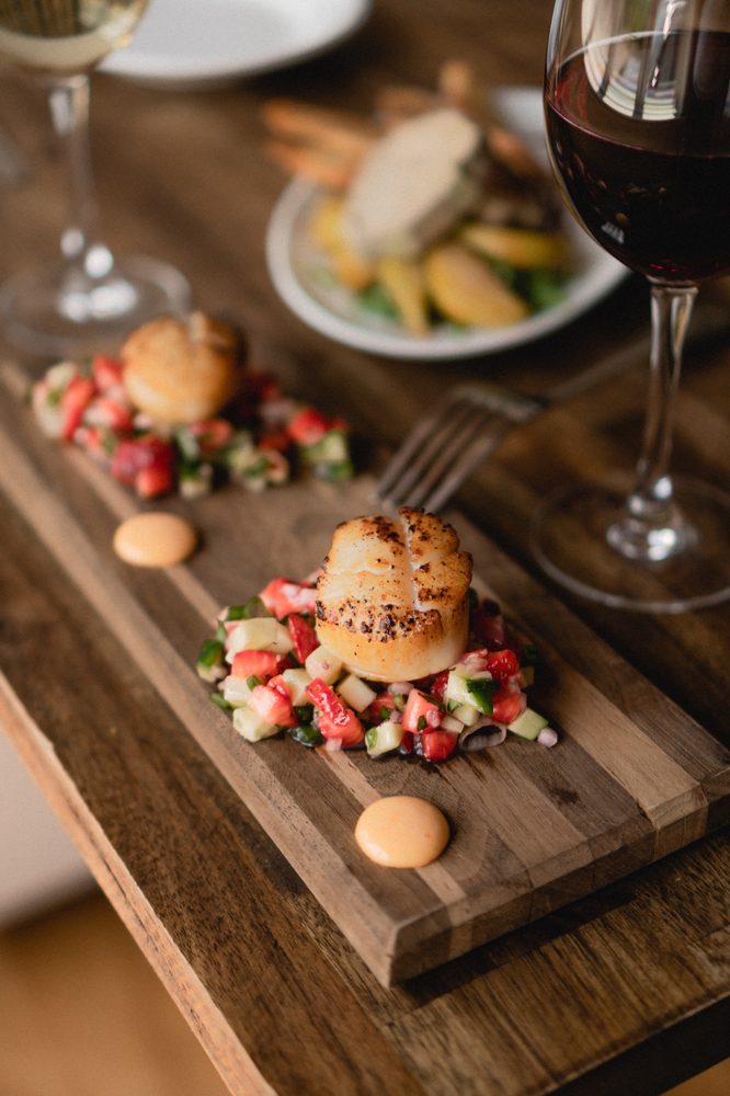 scallop on fruit and wood platter wine pairing