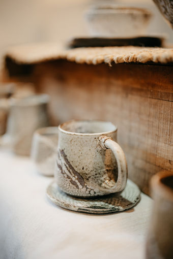 White ceramic mug and plate in Keane's dark matter clay.