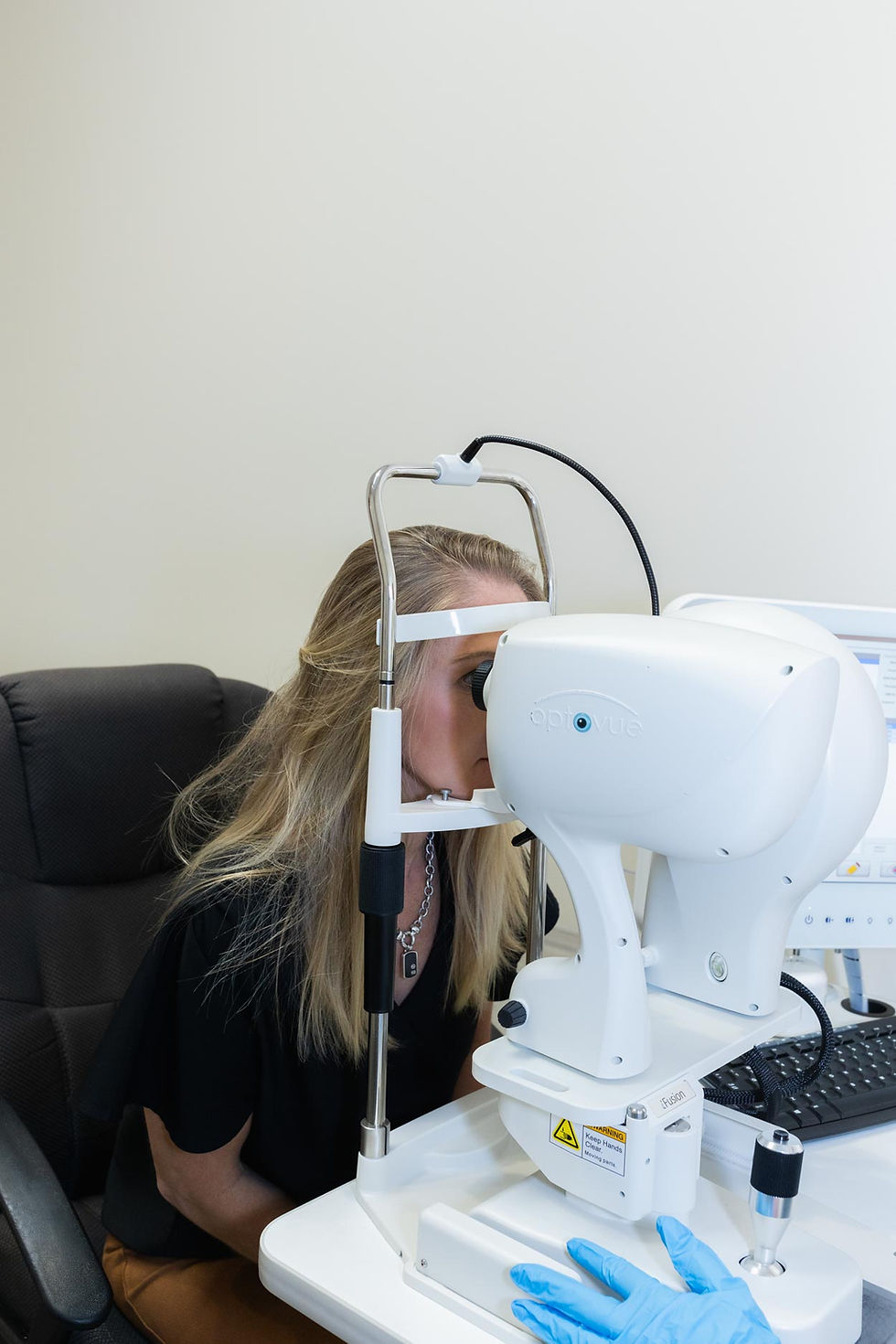 Blonde woman looking into an eye scanner