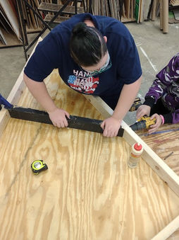 working photo me holding wood.jpg