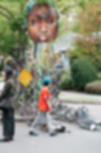 A Walk the Block attendee takes in a sculpture by Marita Dingus, September 2024. Credit Hilary Northcraft.