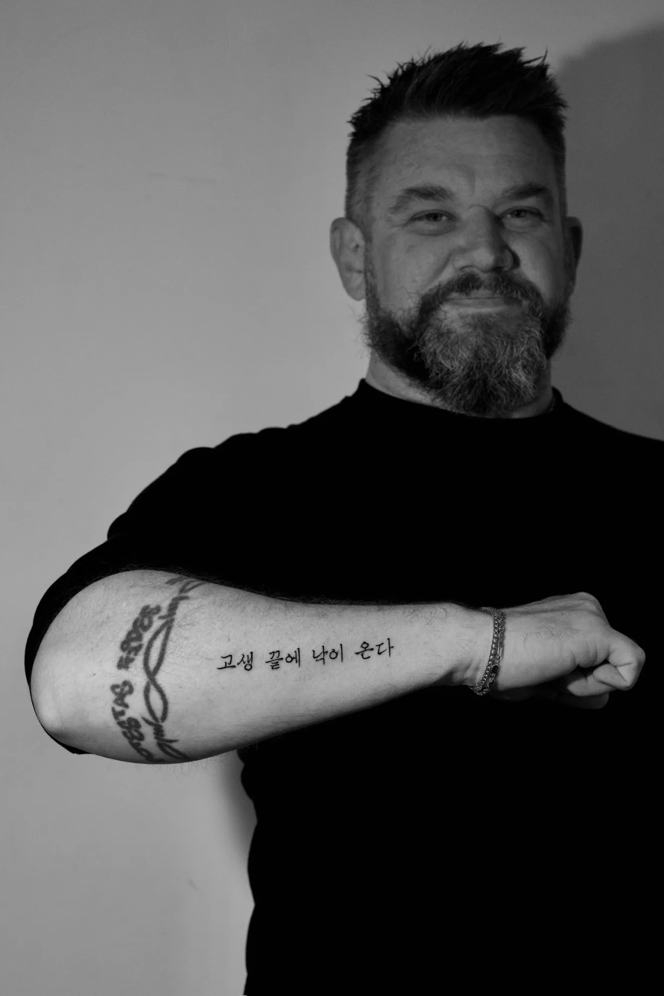 Fineline Korean Hangul quote tattoo reading '고생 끝에 낙이 온다' (meaning 'after hardship comes joy') horizontally along the inner forearm of a male client. Seoul Ink Tattoo, Gangnam, Seoul, South Korea.