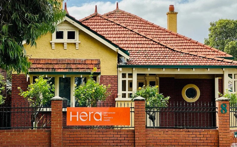 Hera and Radical Embrace building with orange signage