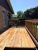 Completed wooden deck with railing and steps