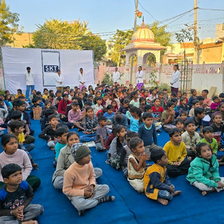 Children listen to Dr. Saini 