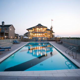 outerbanks home lit at dawn reflecting on private pool