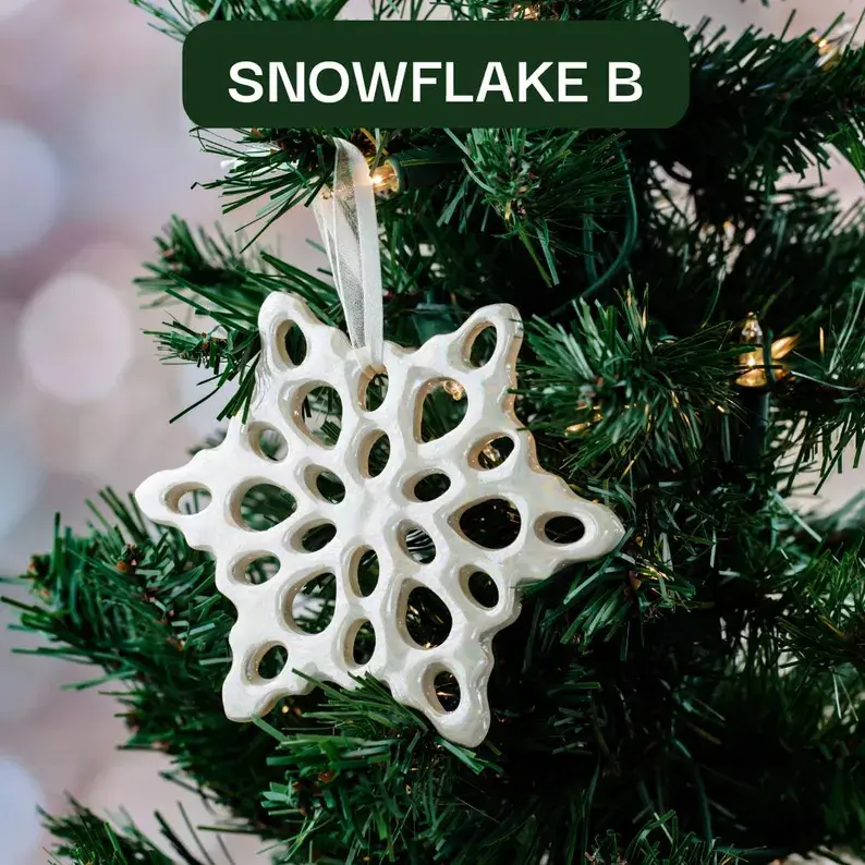 Thumbnail: Handmade Ceramic Iridescent Soft-White Snowflake Christmas Ornament Hanging on Christmas Tree
