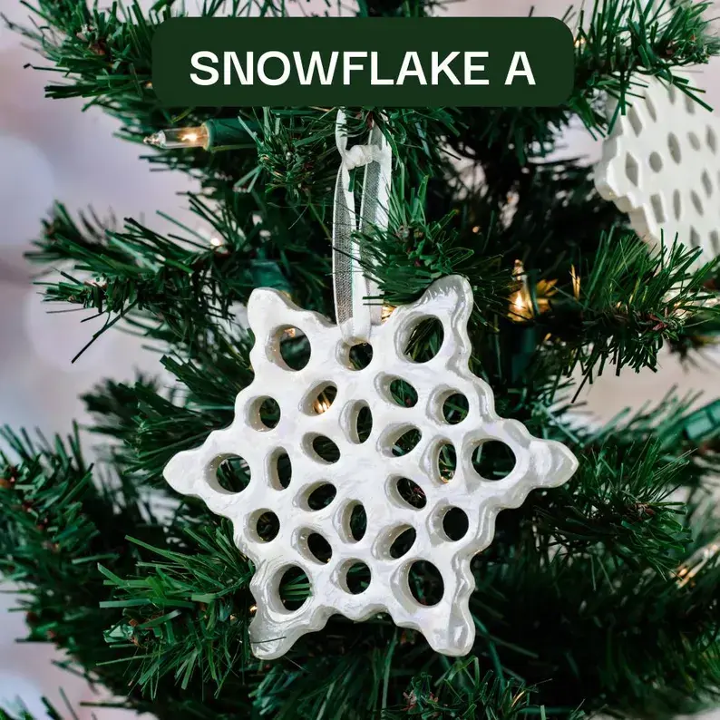Thumbnail: Handmade Ceramic Iridescent Soft-White Snowflake Christmas Ornament Hanging on Christmas Tree