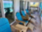 deck adirondack chairs and reflected turquoise waters