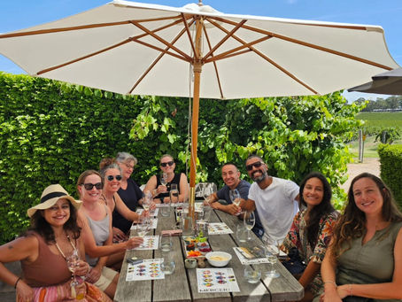 Group of people sitting at a table with drinks