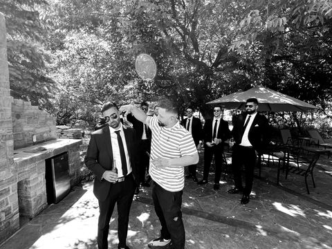 Mobile barbering services by The Groomed Society for weddings, showcasing expert groom preparations with stylish haircuts and grooming in a sophisticated, on-site setting.