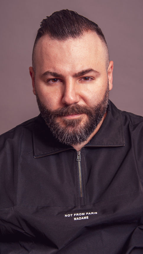 The Groomed Society's expert barbering evident in a model’s stylish and meticulously crafted haircut.