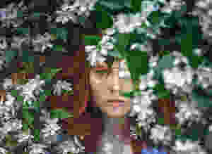 Green eye girl in jasmine bush