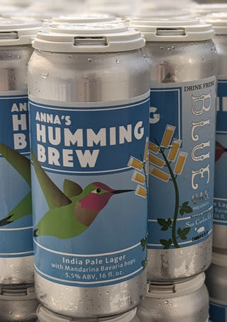 Cans of beer with hummingbird on label.
