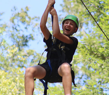 boy smiling on zip line