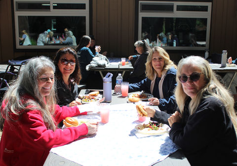 4 smiling ladies at table