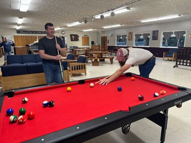 2 guys playing pool