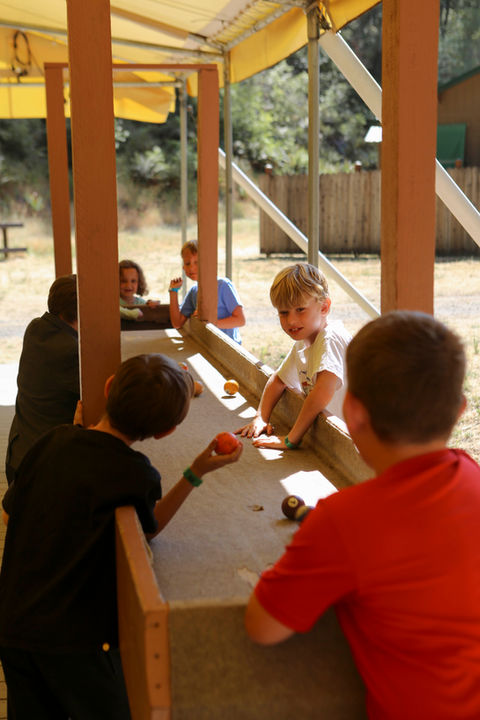 boys playing carpet ball