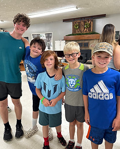 Counselor with 4 young boys smiling