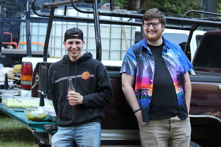 2 guys smiling by tailgate