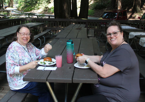 2 ladies eating at table