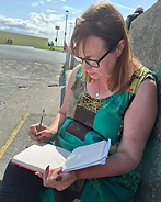 Author writing her daily journal out of doors