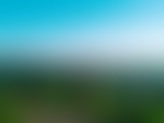 Person standing on a mountain or horizon at sunrise looking forward