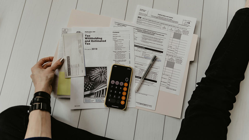 Tax documents, calculator, and self-employment paperwork on floor