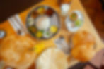 Overhead view of South Indian vegetarian meal at Sagar London with puri bread, rice thali