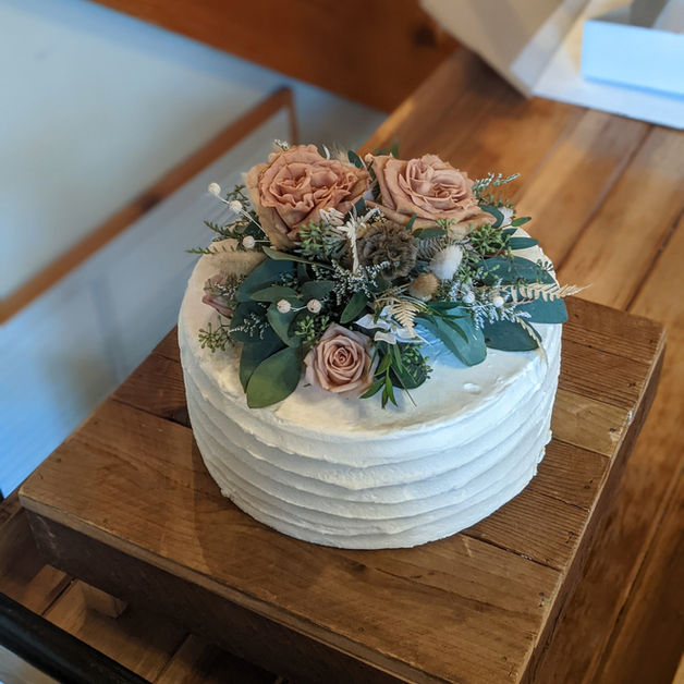 Chocolate and cream cheese wedding cake with live flowers.