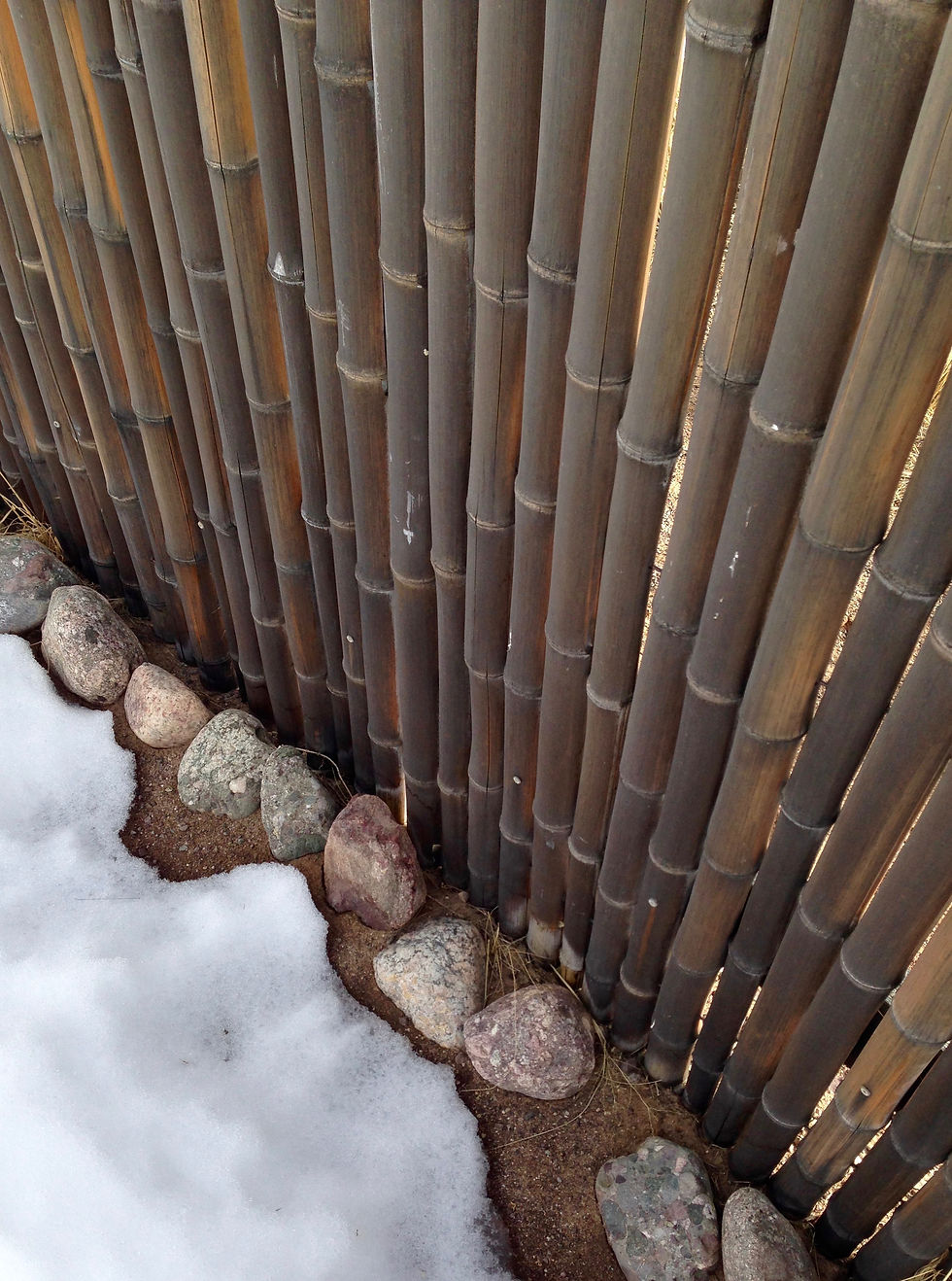 A simple bamboo wall encloses the site. It is sturdy and weathered.