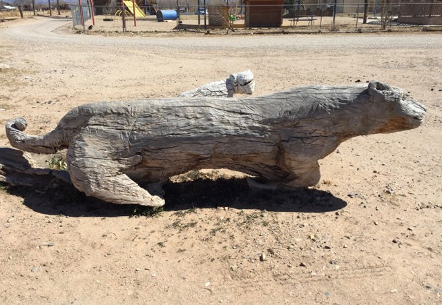 This log, transformed into a bear and a cub (I think), sits in an open area not far from a trail.
