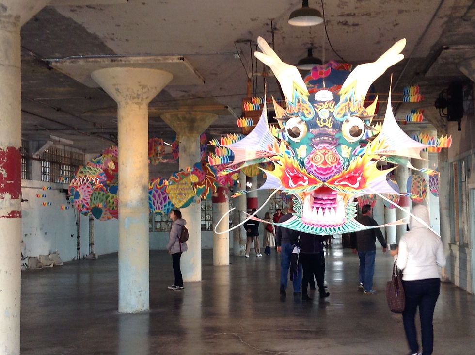 “With Wind” is an example of transforming traditional art into political commentary. Note the crumbling walls and paint, and how the kite, a symbol of freedom, winds itself through the pillars of the space.