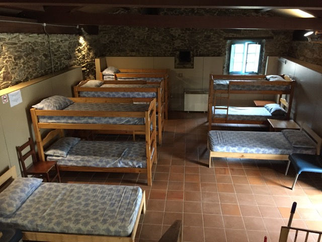This is one of the sleeping areas of our albergue. In two buildings, it had 60 beds but it was never completely full during our weeks. Generally, younger folks are assigned to upper berths and older ones get the lower bunks, but there’s no hard and fast rule. The albergue staff make the assignments; they have an experienced sense of people’s needs.