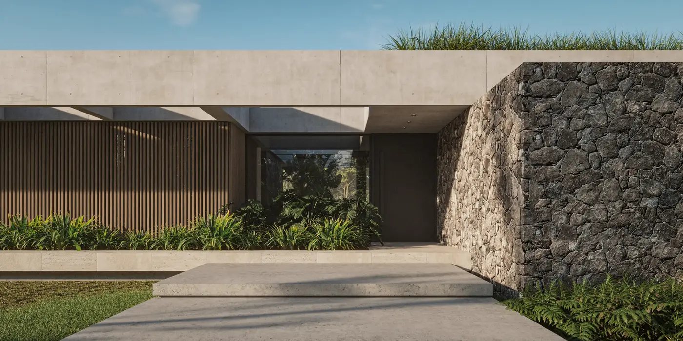 Casa de una planta, es una losa de hormigon visto. Las paredes estan revestidas en piedra y madera. La fachada tiene vegetacion incorporada.
