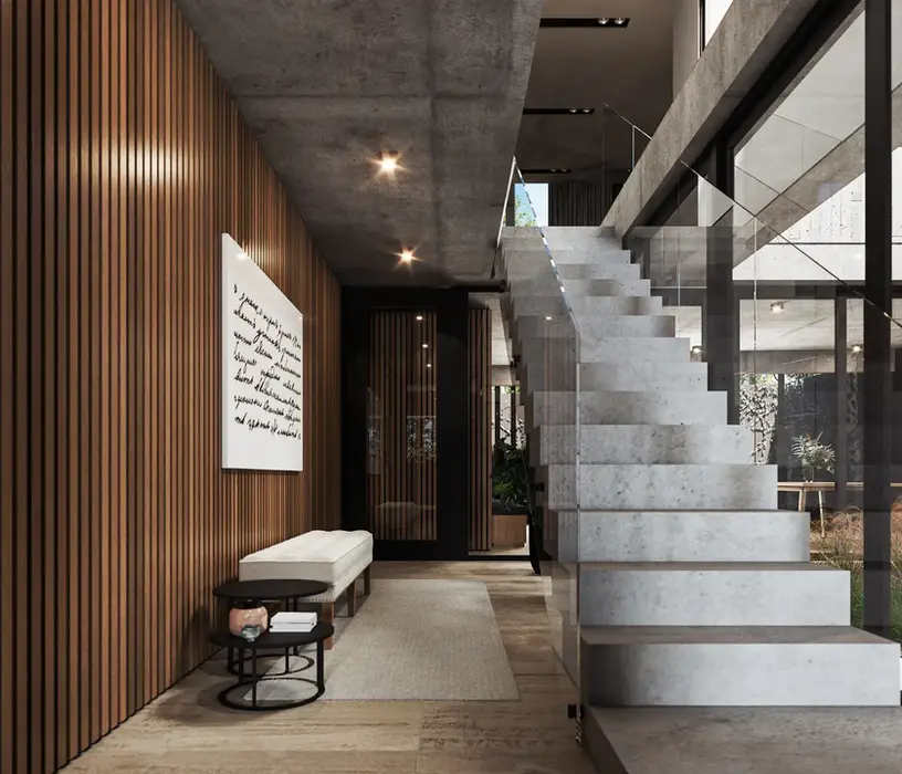 Hall de acceso la losa es de hormigon visto. Los muros estan revestidos en madera. las ventanas son de aluminio negro. la escalera es de hormigon con baranda de vidrio.