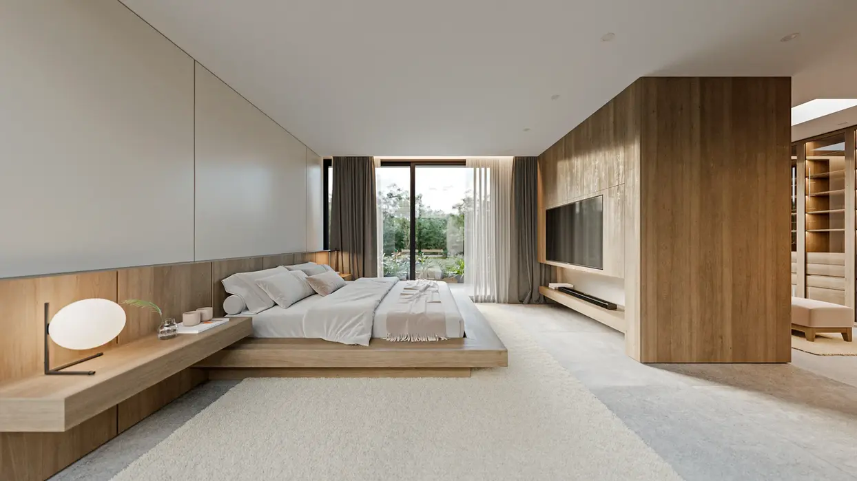 Interior de casa, hay revestimientos de madera y marmol, el piso es de porccelanato y el cielorraso de yeso. Es un living con alfombra y sillon claro. Es un dormitorio principal con un respaldo de cama de madera.