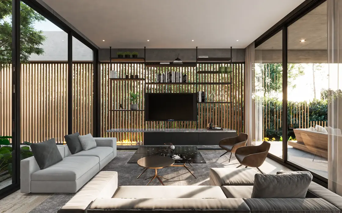 Interior de casa con piso de travertino, carpinteria de aluminio negro. Muros de hormigon visto. Es un estar se ve un mueble de tv. muebles de cuero. un patio al fondo.