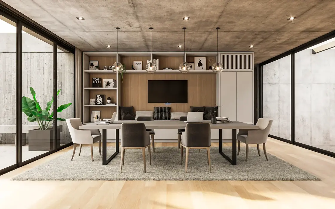 Playrrom con piso de marmol y losa de hormigon visto. hay un ordenador empotrado con un mueble para tv. Una mesa de estudio con sillas y alfombra.