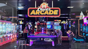 Adults playing arcade games at Chuck E. Cheese’s newly launched adult-focused arcade space.