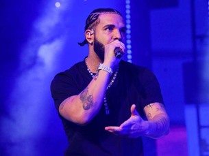 Drake talking on a mic with a blue and purple background