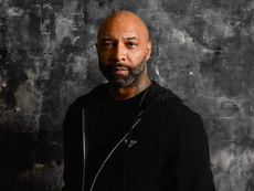 Joe Budden posing for Variety with a black and white background