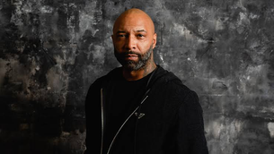 Joe Budden posing for Variety with a black and white background